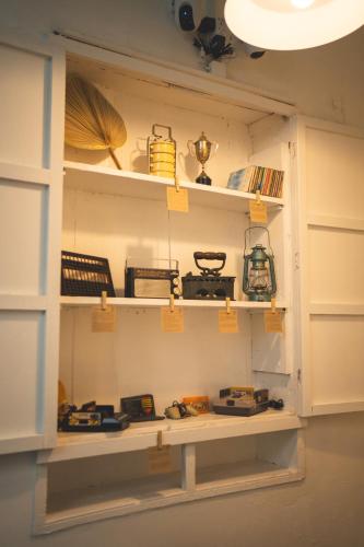 a shelf in a room filled with lots of items at Carnarvon 73 in George Town