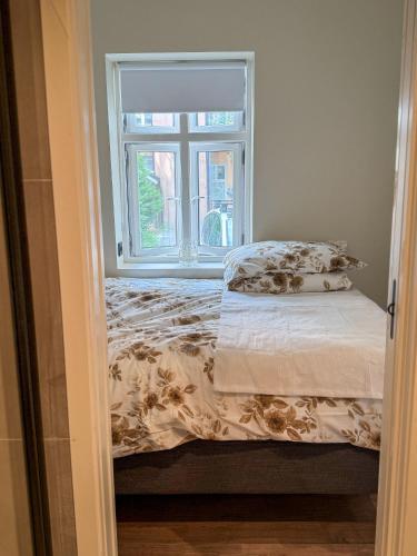 a bed in a room with a window at Nyrenovert Bergenshus med 2 leiligheter - rolig smau i hjertet av Bergen in Bergen