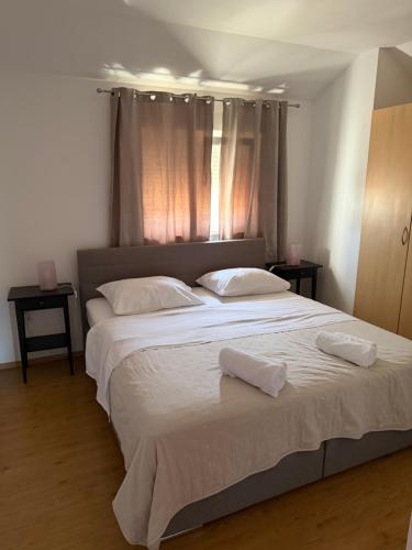 a bedroom with a large bed with two towels on it at Apartments Branimir in Murter