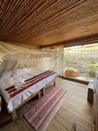 a bedroom with a bed in a tent with a window at Eco Lodge Mancora in Máncora