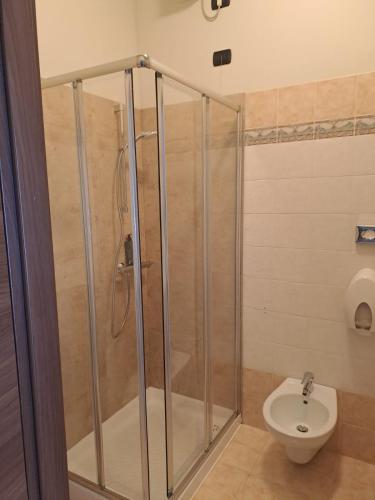 a bathroom with a shower and a toilet at Hotel HDomus in Nogarole Rocca