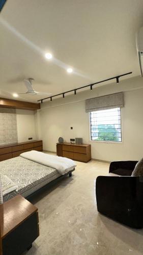 a bedroom with a large bed and a window at Woodlands Apartment- Fully furnished Luxury Apt in Jodhpur