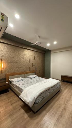 a bedroom with a large bed with a ceiling at Woodlands Apartment- Fully furnished Luxury Apt in Jodhpur