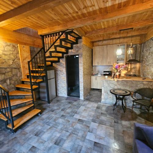 a kitchen with a spiral staircase in a room at Iveria Parky and cottages in Shekvetili