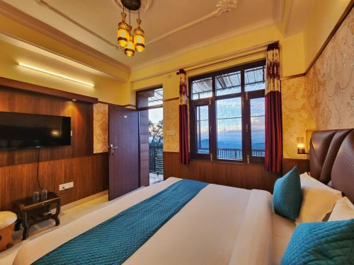 a bedroom with a large bed and a television at Florence B&B Near Mall Road - Amazing Valley View in Shimla