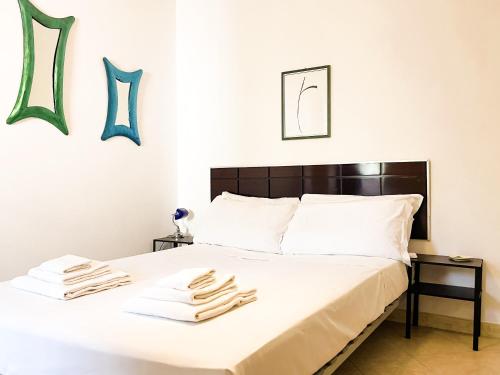 a bedroom with a bed with towels on it at La Tufara Countryside Apartment - Authentic Italian Family Home with free parking in Nocera Inferiore