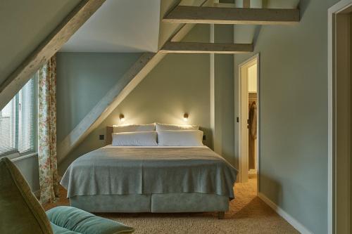 a bedroom with a bed in a attic at Landhaus Jenischpark in Hamburg