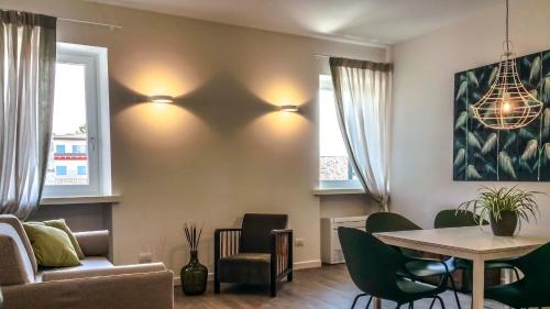 a living room with a table and a couch at Porto Vecchio Appartamenti in Lazise