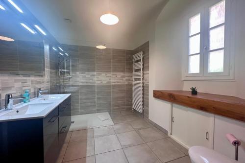 a large bathroom with a sink and a shower at Maison de la Fontaine - Typique - Bourg de Collonges in Collonges la rouge