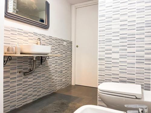 a bathroom with a white toilet and a sink at La Tufara Countryside Apartment - Authentic Italian Family Home with free parking in Nocera Inferiore
