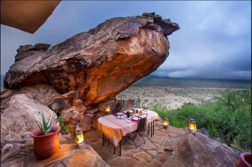 a table set up on top of a large rock at Saruni Samburu in Archers Post
