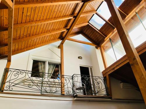 a balcony in a house with a wooden ceiling at Lovely Garden 100m2 apartment in Novi Sad