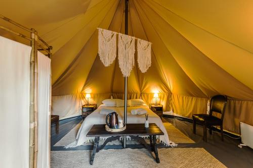 a bedroom with a bed in a tent at OAK Glamping Relax in Manziana