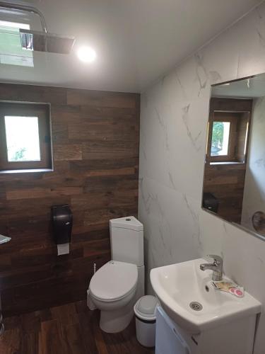 a bathroom with a white toilet and a sink at Complex Magiyata na Rila in Rilski Manastir