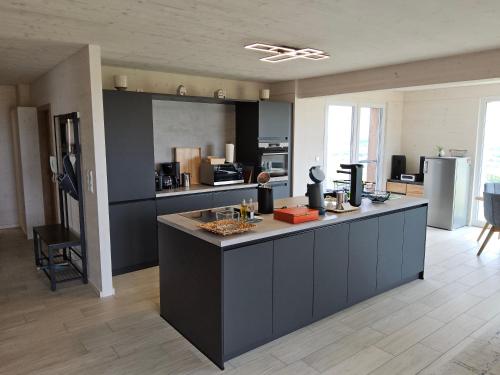 a kitchen with a large island in the middle at Morgenrot Panorama-Apartment 2 - Zwei Balkone in Gnotzheim