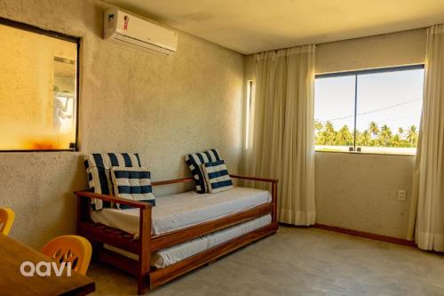 a bedroom with a bed and a large window at Casa com Piscina Privativa Lambari 107 by Qavi in São Miguel dos Milagres