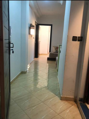 a hallway with a tile floor in a room at Elmerzougui in Azla