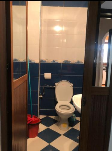 a bathroom with a toilet and a sink at Elmerzougui in Azla