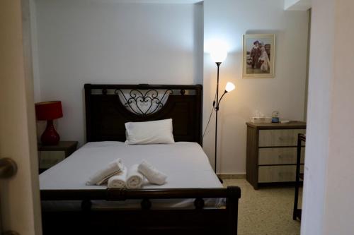 a bedroom with a bed with two towels on it at Zeta Suites 2 Nicosia in Ayios Dhometios