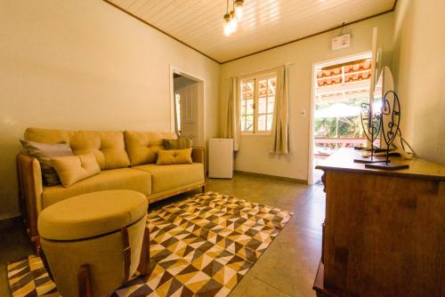 a living room with a couch and a table at Minha Glória Hotel Boutique in Bom Jardim