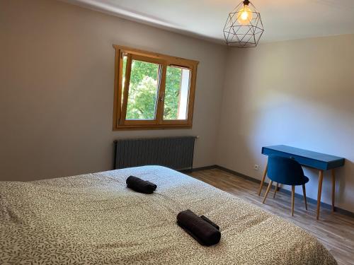 a bedroom with a bed and a blue desk at Gîte de charme dans la vallée du Borne au cœur des Alpes in Glières-Val-de-Borne