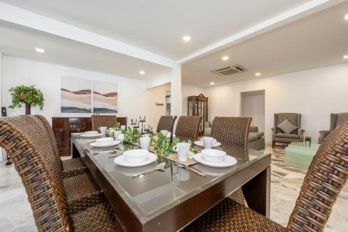 a dining room with a table and chairs at Luxury Bungalow TTDI, 16-22pax, Swimming Pool, One Utama in Kuala Lumpur