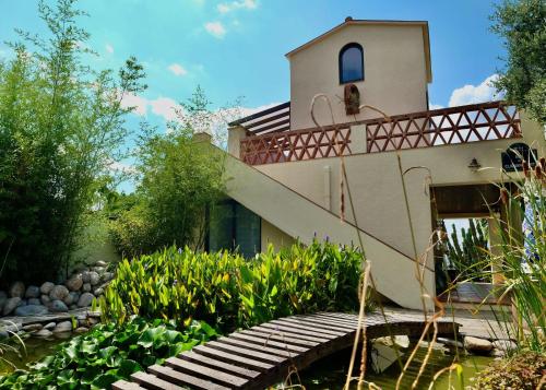 a house with a bridge in a garden at Torre Costa Brava Private pool in Garrigás