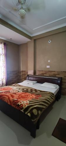 a bedroom with a large bed in a room at Hotel Ishaan International Near Yatra Parchi Counter in Katra