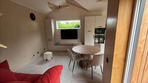 a kitchen and dining room with a table and chairs at Maison de vacances à 200m de la mer in Plouha