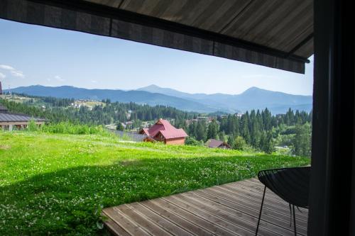 a room with a view of a green field and mountains at ШПИЦІ Hotel & SPA in Bukovel