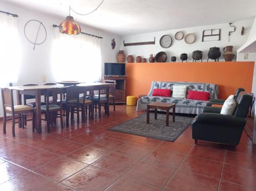 a living room with a table and a couch at Gerês e Cabreira - Casa Alexandrina Vilar in Frades
