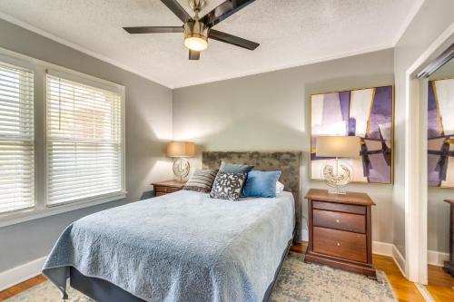a bedroom with a bed and a ceiling fan at 3 Blocks to Pensacola Bay Charming Apartment! in Pensacola