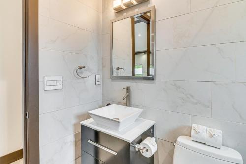 a white bathroom with a sink and a toilet at Private Pool and Sauna Pet-Friendly Reseda Retreat! in Reseda