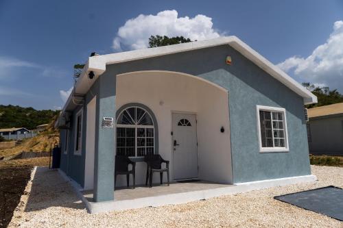 a small dog house with two chairs in it at Paradise View in Discovery Bay