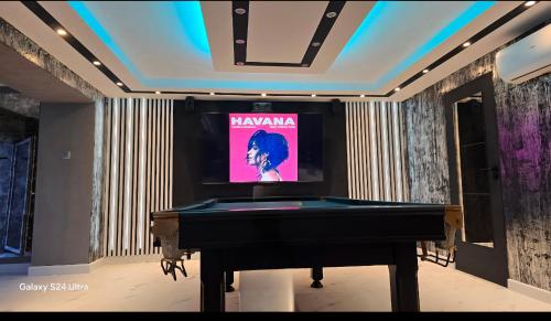 a television in a room with a pool table at Apartament Queen in Ełk