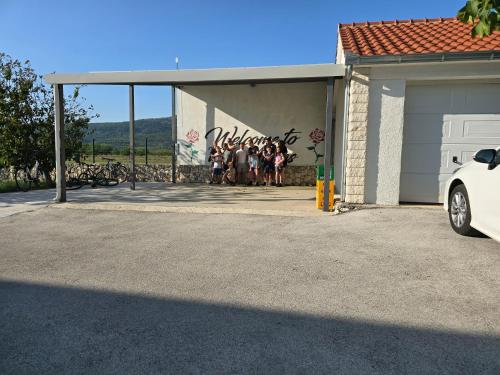 a group of people standing in front of a building at Villa Almas with swimming pool, tennis court, sauna, gym, grill house in Neorić