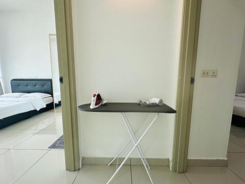 a small table in a room with a bed at Southbay Seaview Condo A31 #10minQueensbay in Bayan Lepas
