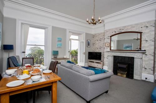 a living room with a couch and a fireplace at Ocean View Apartment in Filey