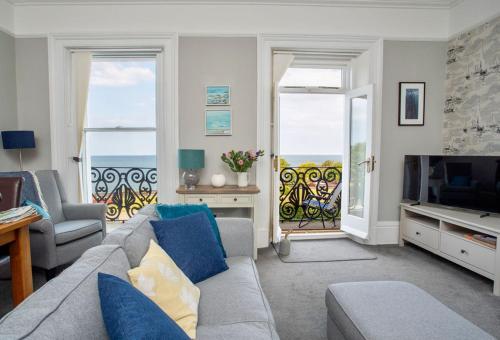 a living room with a couch and a television at Ocean View Apartment in Filey
