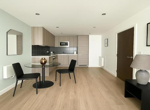 a kitchen and dining room with a table and chairs at 1 Bed Flat in Colindale in Colindale