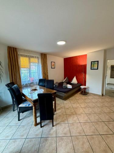 a living room with a table and a couch at Ferienwohnungen Rehn in Dresden