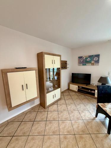 a living room with two cabinets and a tv at Ferienwohnungen Rehn in Dresden