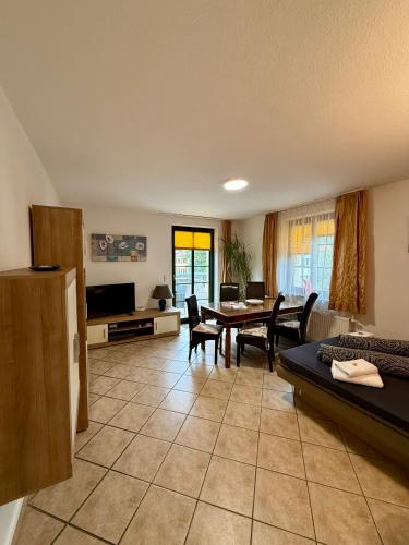 a living room with a table and a couch at Ferienwohnungen Rehn in Dresden