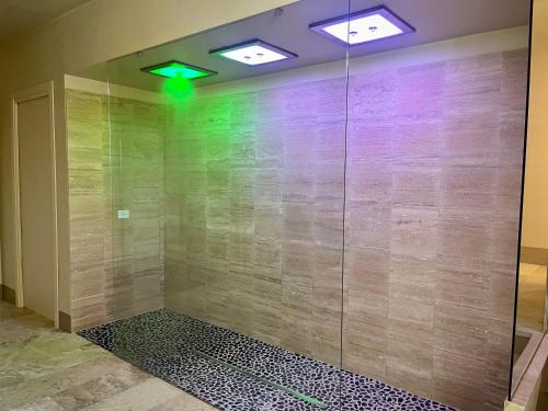 a shower in a room with a glass wall at Nobilis Charme Relais in Montepulciano