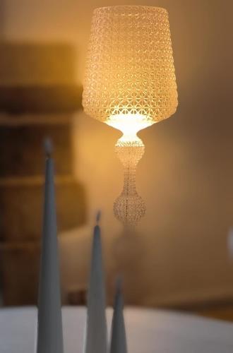 a close up of a table with a lamp at Manoir de Kerenneur in Plourin