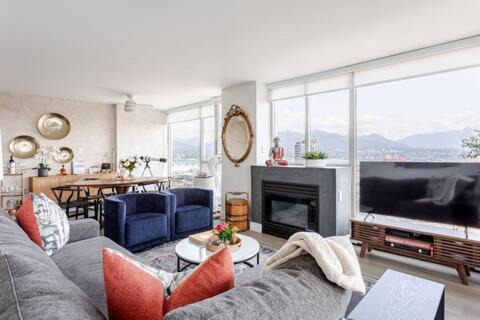 a living room with a couch and a large television at Luxury 2 Bed 2 Bath Condo Downtown Vancouver with Free Parking in Vancouver