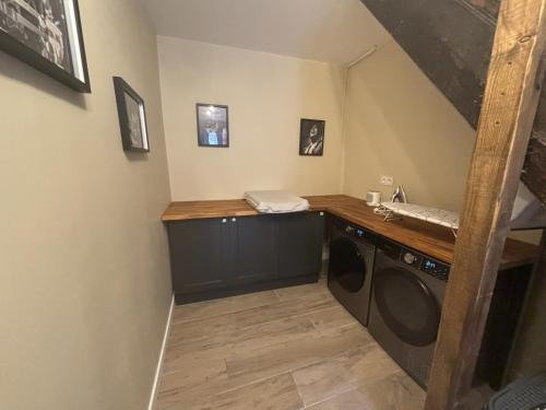 a laundry room with a washer and dryer at Aux 12 instants, Imagine in Lédergues