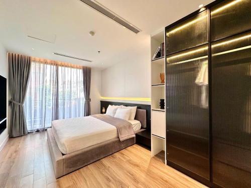 a bedroom with a bed and a large window at The28 Residence in Hanoi