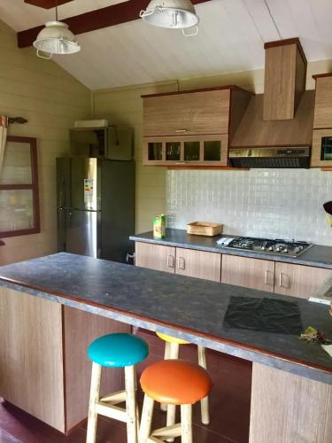a kitchen with two stools sitting at a counter at Charming House in Albion with Shared Pool in Albion