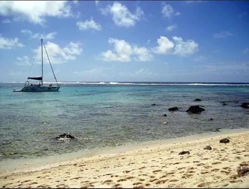 a sail boat in the water on a beach at Charming House in Albion with Shared Pool in Albion